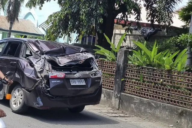A damaged car is seen along a road after a strong quake hit Bangued, Abra province, northern Philippines on Wednesday July 27, 2022. A strong earthquake shook the northern Philippines on Wednesday, causing some damage and prompting people to flee buildings in the capital. Officials said no casualties were immediately reported. (Photo by Raphiel Alzate/AP Photo)