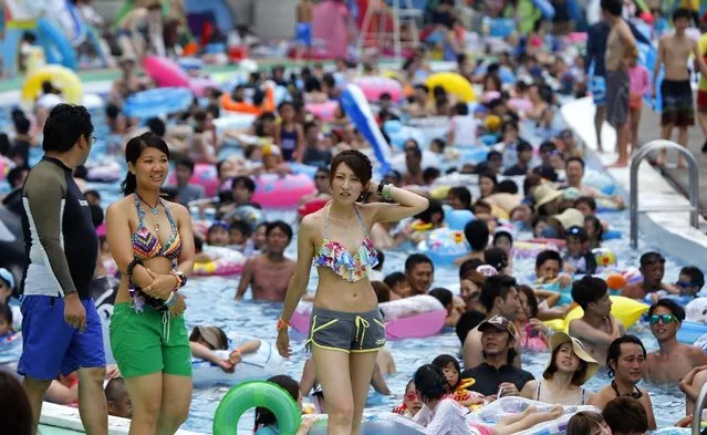 Visitors pack a giant pool at Toshimaen amusement park in Tokyo, Sunday, July 26, 2015. (Photo by Shizuo Kambayashi/AP Photo)