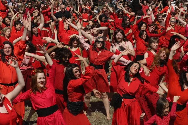 Both men and women dressed as singer Kate Bush from her 1978 video to her song “Wuthering Heights” dance while seeking to create a new world's record for the most people dancing in costume to the song at once at Tempelhofer Feld park on July 16, 2016 in Berlin, Germany. (Photo by Sean Gallup/Getty Images)