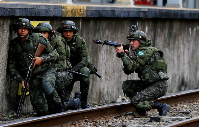 Brazilian army soldiers are pictured as they attend an exercise during terrorist attack simulation at a train station, ahead of the Rio 2016 Olympic Games in Rio de Janeiro, Brazil July 16, 2016. (Photo by Bruno Kelly/Reuters)