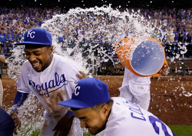 Jarrod Dyson #1 and Christian Colon #24 of the Kansas City Royals are doused with water by catcher Salvador Perez #13 after the Royals defeated the Cleveland Indians 7-3 to win the game at Kauffman Stadium on July 18, 2016 in Kansas City, Missouri. (Photo by Jamie Squire/Getty Images)