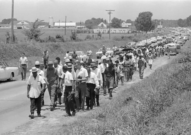 In this June 9, 1966 file photo, civil rights activists led by Dr. Martin Luther King stretch out along Highway 51 south near Senatobia, Miss., on a march to the capital, Jackson, started by James Meredith. The March Against Fear helped many find a voice to protest the injustices of the day. (Photo by AP Photo)