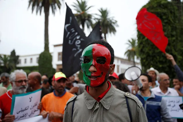A masked man attends a demonstration called by Morocco's February 20 protest movement over a corruption scandal that the movement claims to involve ministers who received parcels of land in a business dealing, in Rabat, Morocco August 3, 2016. (Photo by Youssef Boudlal/Reuters)