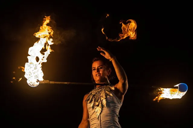 A member of the “Firebirds and Flame Flowers” group performs during the 28th Sziget (Island) Festival on Shipyard Island, Northern Budapest, Hungary, 11 August 2022. The festival is one of the biggest cultural events of Europe offering art exhibitions, theatrical and circus performances and above all music concerts. (Photo by Marton Monus/EPA/EFE)