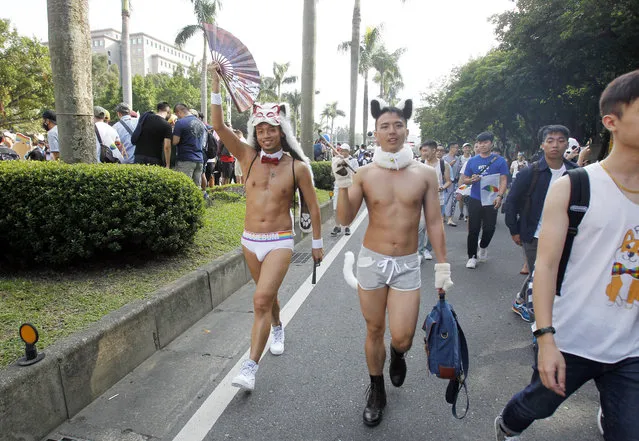 Participants revel through a street during the gay and lesbian parade in Taipei, Taiwan, Saturday, October 28, 2017. Taiwan's Constitutional Court ruled in favor of same-s*x marriage on May 24, 2017, making the island the first place in Asia to recognize gay unions. (Photo by Chiang Ying-ying/AP Photo)