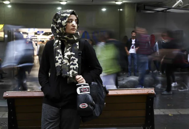 17-year-old student, female boxer and “Hafiz” Zeynep Gul Caylar waits for the train at a subway station in Ankara Turkey on October 25, 2017. Tevfik Ileri Religious High School's 10th grade student Zeynep Gul Caylar wants to be the champion of Turkey after winning the Ankara championship in the boxing sport that she has been interested in for four years as well as the achievements she has shown in the Holy Quran memorizing training and poetry writing. Because of his interest in foreign languages, Caylar learned Arabic as well as English. She won the first and the third place in two Arabic poetry contests and won sixth place overall in Turkey. “Hafiz”, literally meaning “guardian” or “memorizer”, depending on the context, is a term used by Muslims for someone who has completely memorized the Qur'an. (Photo by Guven Yilmaz/Anadolu Agency/Getty Images)