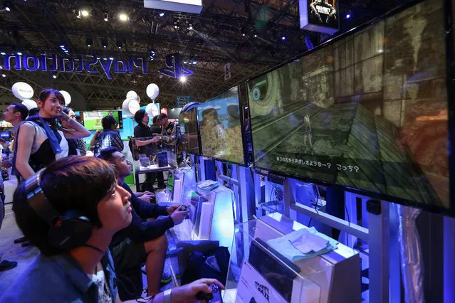 Visitors play the video game Gravity Daze at the Sony PlayStation booth during the 2015 Tokyo Game Show at Makuhari Messe Convention Center in Chiba prefecture, east of Tokyo, Japan, 17 September 2015. Asia's biggest gaming event kicked off with a record high number of exhibitors consisting of 480 exhibitors and organizations from 37 different countries. (Photo by Christopher Jue/EPA)
