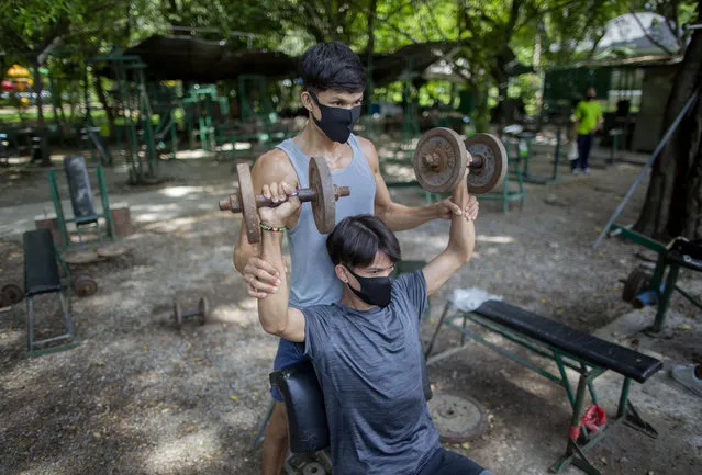 Men exercise in an outdoor gym in a park in Bangkok, Thailand, Wednesday, June 10, 2020. Daily life in the capital is resuming to normal as Thai government continues to ease restrictions related to running business in capital Bangkok that were imposed weeks ago to combat the spread of COVID-19. (Photo by Gemunu Amarasinghe/AP Photo)