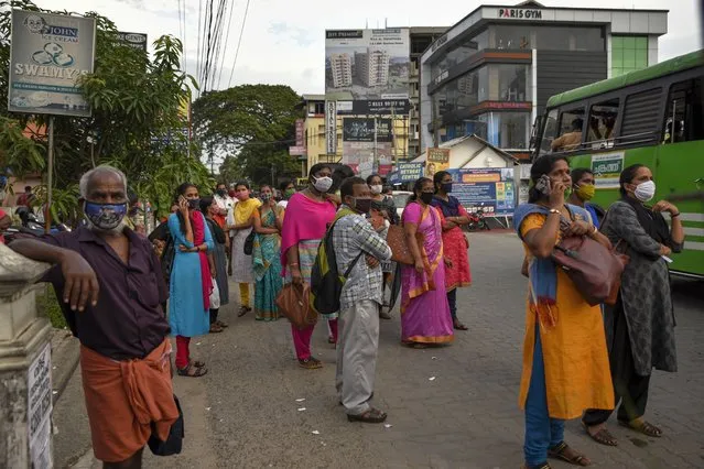 People wearing masks as a precaution against the coronavirus wait for transportation in Kochi, Kerala state, India, Thursday, June 25, 2020. India is the fourth hardest-hit country by the COVID-19 pandemic in the world after the U.S., Russia and Brazil. (Photo by R.S. Iyer/AP Photo)