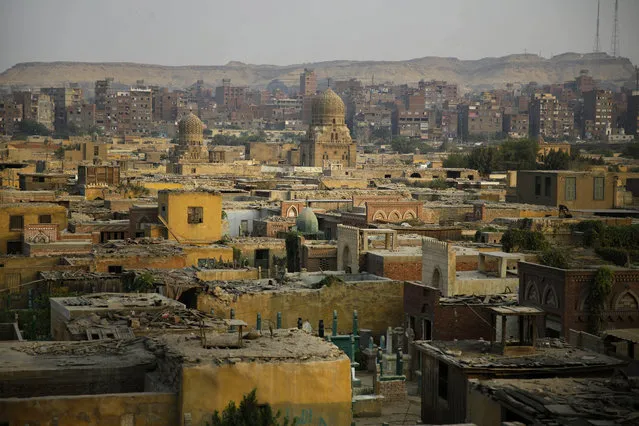 This Oct. 10, 2014, photo shows a general view of cemeteries located in the City of the Dead, a slum where half a million people live among tombs, in Cairo. The reality of relying on finite land resources to cope with the endless stream of the dying has brought about creative solutions. (AP Photo/Hassan Ammar)