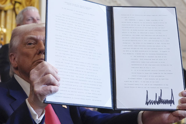 President Donald Trump holds a signed executive order during an event in the East Room of the White House, Tuesday, April 8, 2025, in Washington. (Photo by Evan Vucci/AP Photo)