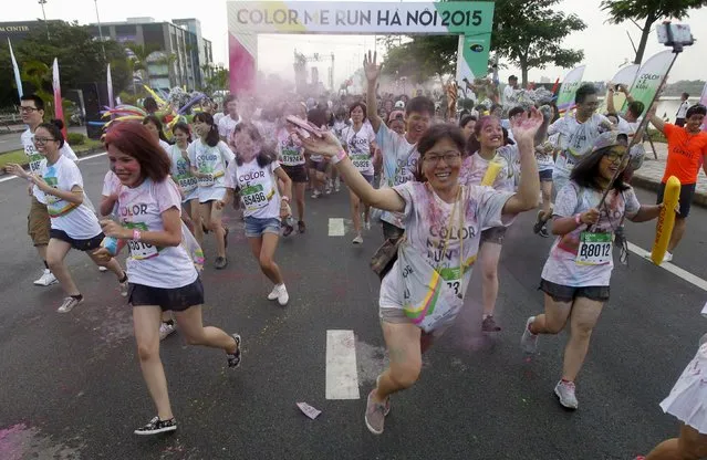 Participants are covered by colored powder as they compete in The Color Run, a five-kilometre untimed race, in Hanoi, Vietnam September 26, 2015. (Photo by Reuters/Kham)