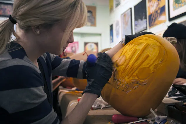 A workshop attendee is carving a ZeroFriend design on her pumpkin at Cotton Candy Machine in Brooklyn, N.Y. on October 18, 2014. (Photo by Siemond Chan/Yahoo Finance)