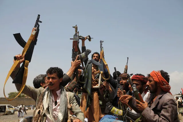 Houthi fighters react while riding on the back of a truck as they attend a tribal gathering in Yemen's capital Sanaa, August 11, 2016. (Photo by Mohamed al-Sayaghi/Reuters)