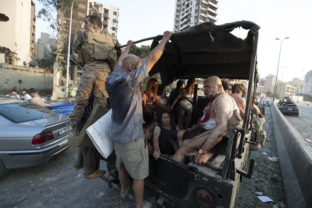 Army soldiers evacuate injured people after a massive explosion in Beirut, Lebanon, Tuesday, August 4, 2020. (Photo by Hassan Ammar/AP Photo)