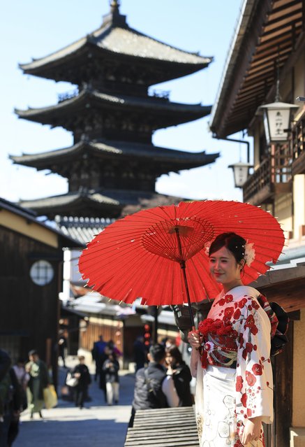 A general view of Hokan-ji Temple, an example of Japanese Buddhist architecture also known as Yasaka Pagoda, and its surroundings in the Gion district of Kyoto, Japan on March 09, 2025. Known for its historic wooden buildings, tea houses, geishas, and women in traditional kimonos, the area attracts thousands of domestic and international tourists each year. At the nearby Yasaka Koshin-do Temple, colorful cloth pouches called kukurizaru, used as traditional charms with written wishes, capture the attention of many visitors. (Photo by Aytug Can Sencar/Anadolu via Getty Images)