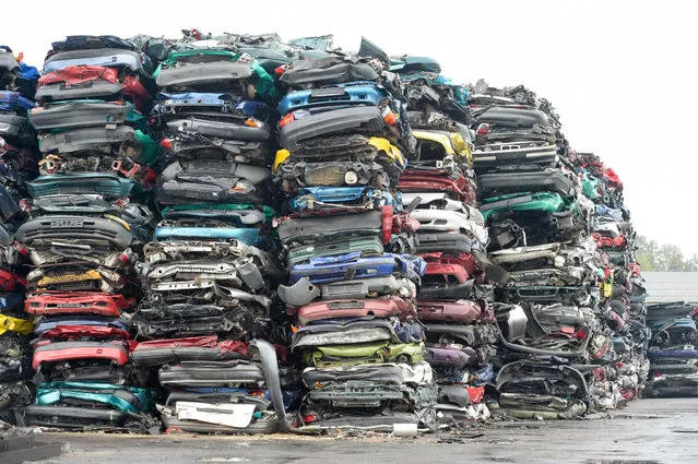 Compressed cars piled up in freight-friendly bales of scrap await their transport on October 6, 2015 on the grounds of a car recycling company in Krostitz, eastern Germany. (Photo by Peter Endig/AFP Photo/DPA)