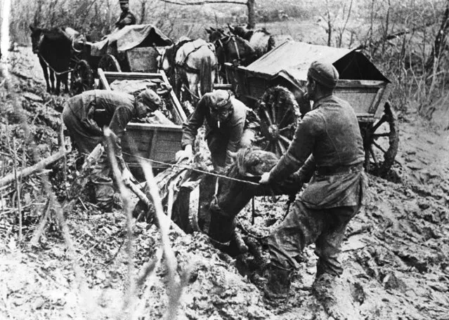 Taken in the North West Calcasus area, it shows men of a German transport unit attempting to extricate one of their horses from the Russian mud in which it was sunk up to its neck, somewhere in Russia on December 20, 1942. (Photo by AP Photo)