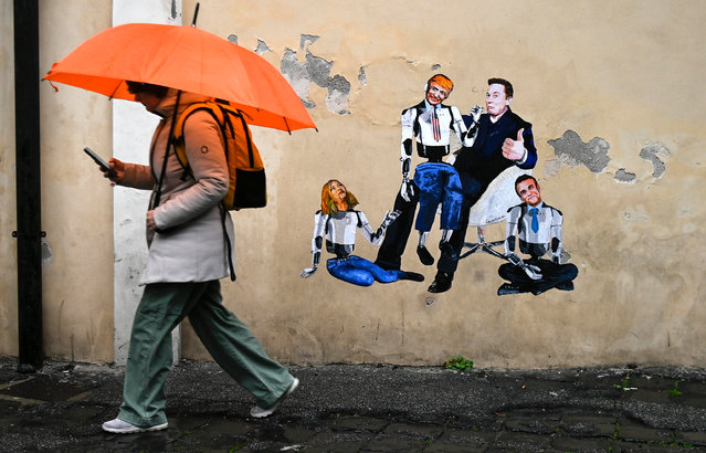 A man walks past a mural by Italian artist Harry Greb depicting Elon Musk as a puppeteer and Donald Trump, Giorgia Meloni and Emmanuel Macron as his puppets, in Rome, Italy, 20 January 2025. (Photo by Riccardo Antimiani/EPA/EFE)