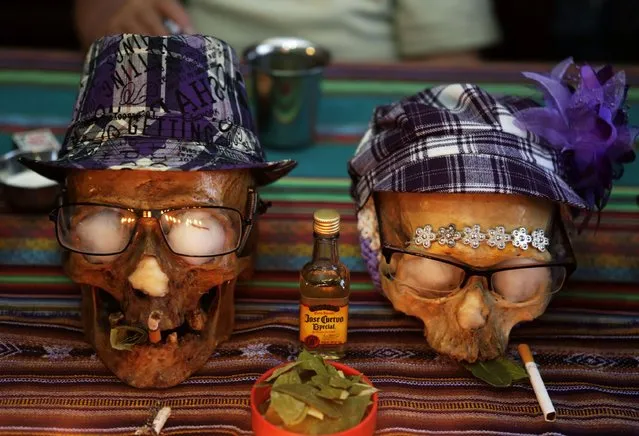 Skulls of Paulino and Juanita are seen on a table a day before the “Dia de los natitas” (Day of the Skull) celebrations at the General Cemetery of La Paz November 7, 2014. Bolivians, who keep close relatives' skulls at home as a macabre talisman, flock to the cemetery chapel once a year to have the craniums blessed and to bring themselves good luck in the future. Picture taken on November 7. (Photo by David Mercado/Reuters)