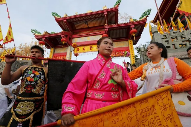 Devotees of the Chinese Jui Tui shrine walk with a piercing on their cheeks during a procession celebrating the annual vegetarian festival in Phuket, Thailand October 19, 2015. (Photo by Jorge Silva/Reuters)