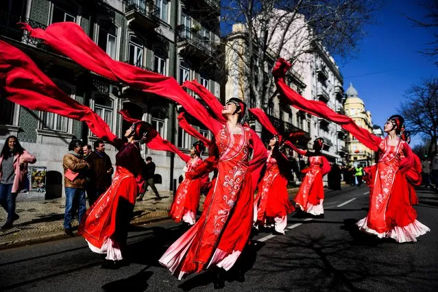 Revelers perform during celebrations for the Chinese New Year parade, marking the year of the Dog, in Lisbon on February 10, 2018. (Photo by Patricia De Melo Moreira/AFP Photo)