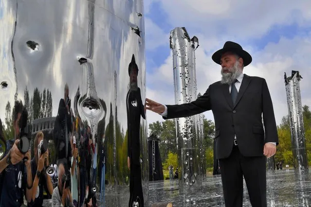 A Jewish man touches an installation opened at Babyn Yar on September 29, 2020 during a ceremony marking the 79th anniversary of the beginning of mass execution of Jews by the Nazis in September 1941. The Babyn Yar (Babiy Yar) ravine in Kiev was the location where Nazis shot dead several tens of thousands of Jews. (Photo by Sergei Supinsky/AFP Photo)