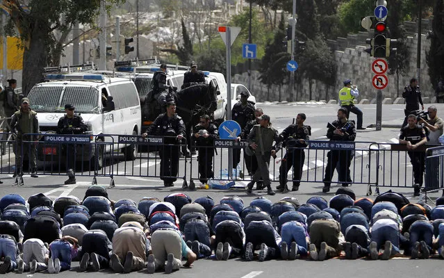 Israeli policemen stand guard in Jerusalem's Old City. Israeli police declared an age limit on Friday for Palestinians wanting to enter the Old City, only allowing males above the age of 50 and all females to enter. (Photo by Ammar Awad/Reuters)