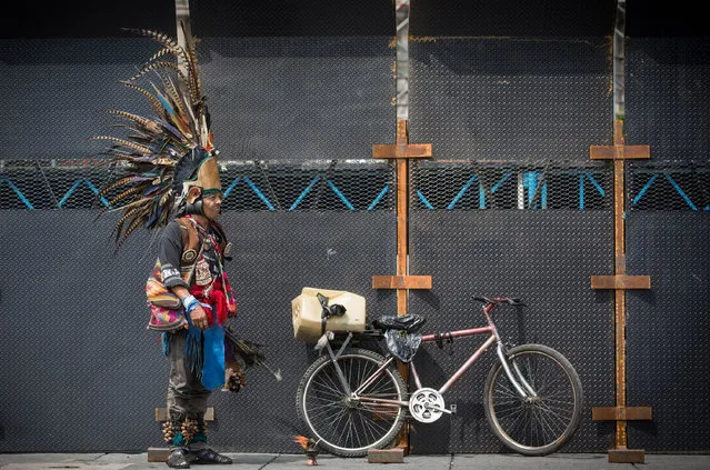 A man wearing a pre-hispanic plume costume is seen during a march commemorating the anniversary of the Tlatelolco Massacre in Mexico City, Mexico on October 02, 2016. Mexicans commemorate the anniversary of the 1968 massacre where many civilians, including students were killed by the security forces. (Photo by Daniel Cardenas/Anadolu Agency/Getty Images)