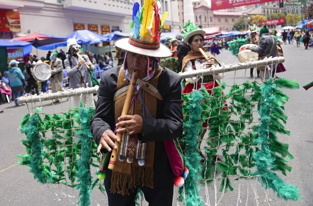 An Aymara Indigenous musician plays a “pinquillo” instrument during the “Jisk'a Anata”, or “Small party” in Aymara, as part of Carnival celebrations in La Paz, Bolivia, Monday, February 20, 2023. (Photo by Juan Karita/AP Photo)