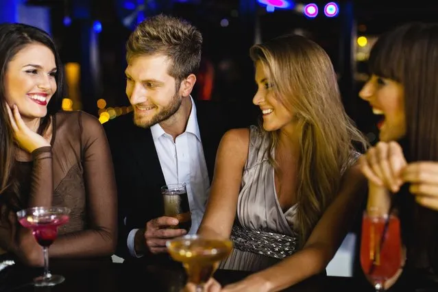 Man talking to women at bar. (Photo by Hybrid Images/Getty Images/Cultura RF)