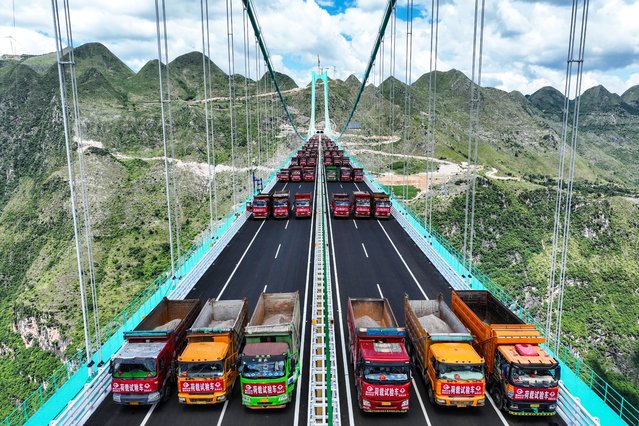 This aerial drone photo taken on Aug. 25, 2025 shows a load test on the Huajiang Grand Canyon Bridge in southwest China's Guizhou Province The Huajiang Grand Canyon Bridge, set to become the world's tallest bridge, had completed a key load test as of Monday, ahead of its scheduled opening in late September The bridge is 2,890 meters long with a main span of 1,420 meters. Rising 625 meters above the river, it will set the record for both the tallest bridge in the world and the world's largest span bridge built in a mountainous area, upon completion. (Photo by AFP Photo/China Stringer Network)