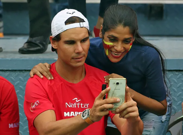 Spain's Rafael Nadal takes a selfie with a fan during the Davis cup tie against India in Delhi, India, September 18, 2016. (Photo by Cathal McNaughton/Reuters)