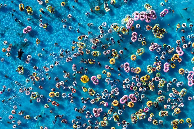 In an aerial view, local residents cool off at a water park amid scorching temperatures on August 23, 2025 in Nanjing, Jiangsu Province of China. High temperatures in summer have triggered new vitality of the cooling economy across China. (Photo by Fang Dongxu/VCG via Getty Images)