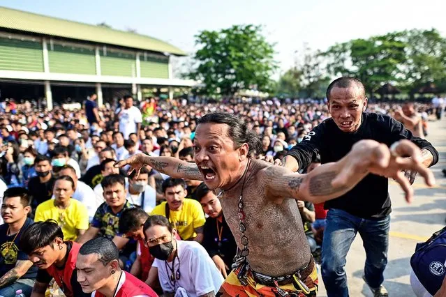 A Buddhist devotee with traditional “Sak Yant” tattoos runs in a state of trance during an annual sacred tattoo festival at the Wat Bang Phra temple in Nakhon Pathom province on March 4, 2023. (Photo by Manan Vatsyayana/AFP Photo)