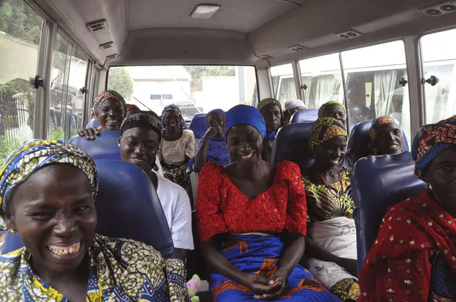 Family members of the Nigerian Chibok kidnapped girls share a moment as they depart to the Nigerian minister of women affairs in Abuja, Nigeria, Tuesday, October 18, 2016. Nigeria's government is negotiating the release of another 83 of the Chibok schoolgirls taken in a mass abduction two-and-a-half years ago, but more than 100 others appear unwilling to leave their Boko Haram Islamic extremist captors, a community leader said Tuesday. (Photo by Olamikan Gbemiga/AP Photo)