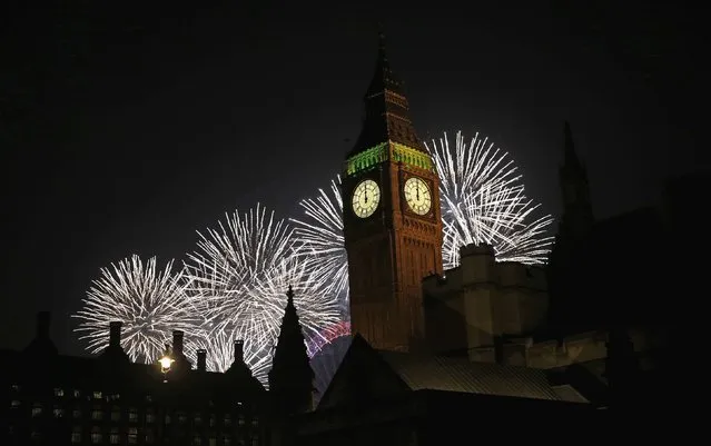 Fireworks explode behind the Houses of Parliament and Big Ben on the River Thames during New Year's celebrations in London January 1, 2015. (Photo by Suzanne Plunkett/Reuters)