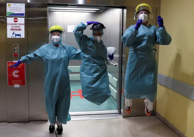 Medical personnel jump in the COVID-19 unit at the CHR Centre Hospitalier Regional de la Citadelle Hospital, during the coronavirus disease (COVID-19) outbreak, in Liege, Belgium, April 22, 2020. (Photo by Yves Herman/Reuters)