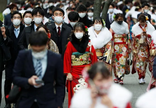 Youth including Kimono-clad women wearing protective face masks attend their Coming of Age Day celebration ceremony at Yokohama Arena after the government declared the second state of emergency for the capital and some prefectures, amid the coronavirus disease (COVID-19) outbreak, in Yokohama, Japan on January 11, 2021. (Photo by Issei Kato/Reuters)