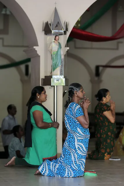 In this Wednesday, January 7, 2015 photo, Sri Lankan Catholic women pray at a church in Colombo, Sri Lanka. (Photo by Eranga Jayawardena/AP Photo)