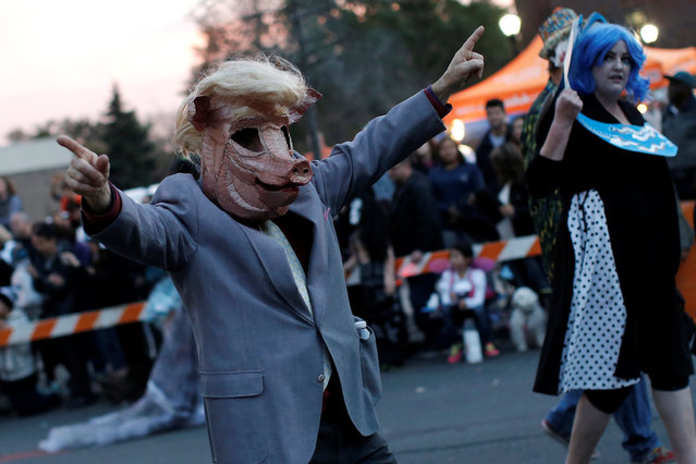 A man dressed as a “Donald Trump pig” marches in the annual Nyack Halloween Parade in the Village of Nyack, New York, U.S., October 29, 2016. (Photo by Mike Segar/Reuters)