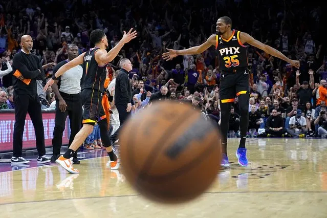 Phoenix Suns guard Devin Booker celebrates a basket with forward Kevin Durant (35) during the first half of Game 3 of an NBA basketball Western Conference semifinal game against the Denver Nuggets, Friday, May 5, 2023, in Phoenix. The Suns defeated the Nuggets 121-114. (Photo by Matt York/AP Photo)