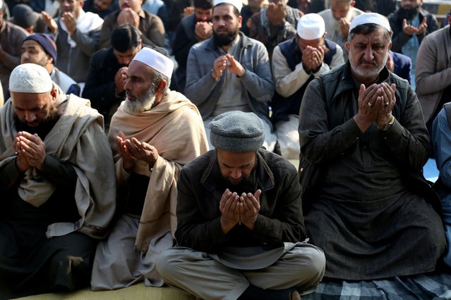 People gather for a congregational rain-seeking prayer at a park in Peshawar, Pakistan, 08 December 2025. Punjab's air quality has sharply deteriorated, with Lahore topping global pollution rankings as dense smog spreads across the province. Authorities issued alerts, stepped up inspections, and deployed drones, while health advisories urged residents to limit outdoor activities amid persistent stagnant winter weather. (Photo by Arshad Arbab/EPA)
