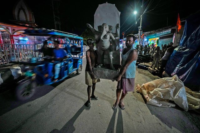 Artisans carry a mud idol of the Hindu god Ganesha outside a workshop ahead of the Durga Puja festival in Guwahati, India, Wednesday, October 2, 2024. (Photo by Anupam Nath/AP Photo)