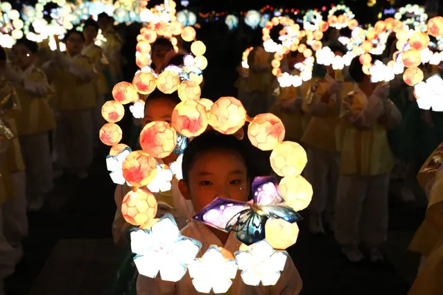 Buddhists carry lanterns in a parade during the Lotus Lantern Festival to celebrate the upcoming birthday of Buddha on May 20, 2023 in Seoul, South Korea. Buddha was born approximately 2,567 years ago, and although the exact date is unknown, Buddha's official birthday is celebrated on the full moon in May in South Korea, which is on May 27 this year. (Photo by Chung Sung-Jun/Getty Images)