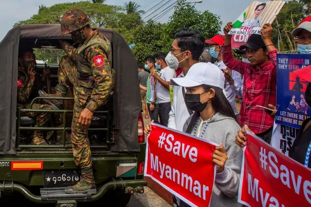 A soldier steps out of a military vehicle outside Myanmar's Central Bank during a protest against the military coup, in Yangon, Myanmar, February 15, 2021. (Photo by Reuters/Stringer)