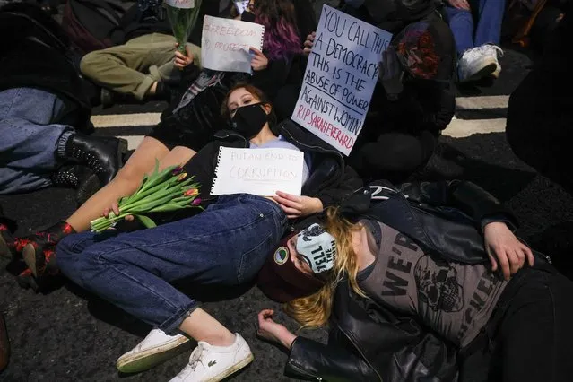 Demonstrators lay down during a protest outside New Scotland Yard, following the kidnap and murder of Sarah Everard, in London, Britain on March 15, 2021. (Photo by Henry Nicholls/Reuters)