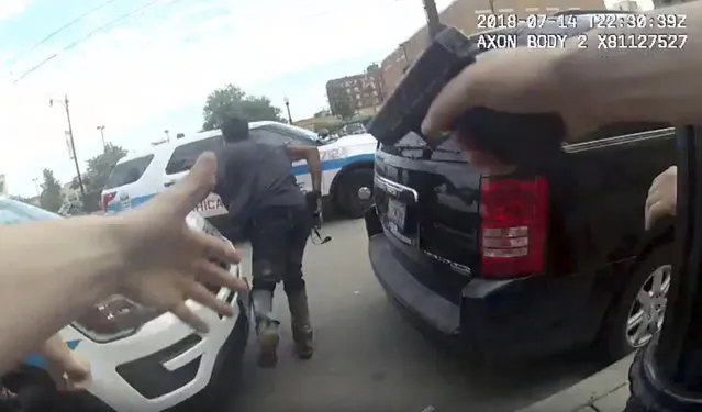This frame grab from police body cam video provided by the Chicago Police Department shows authorities trying to apprehend a suspect, center, who appeared to be armed, Saturday, July 14, 2018, in Chicago. The suspect was fatally shot by police during the confrontation. (Photo by Chicago Police Department via AP Photo)