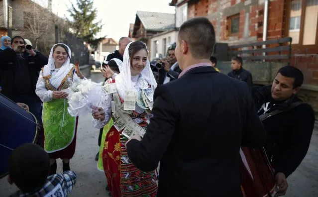 Bulgarian Muslims bride Fikrie Bindzheva (C left) dances next to her groom Azim Liumankov during their wedding ceremony in the village of Ribnovo, in the Rhodope Mountains, February 15, 2015. (Photo by Stoyan Nenov/Reuters)
