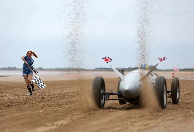 Motoring enthusiasts take part in the “Race The Wave” classic car meet on the beach at Bridlington, Britain, June 18, 2022. (Photo by Lee Smith/Reuters)